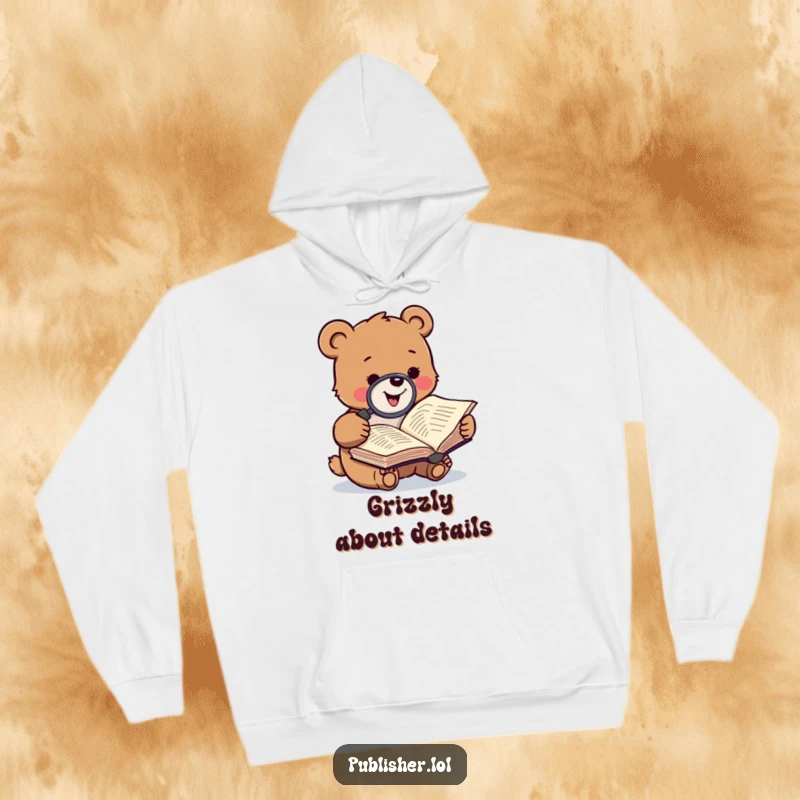 Funny hoodie depicting a gleeful small bear character closely examining a manuscript with a magnifying glass, perfect for cozy reading sessions.