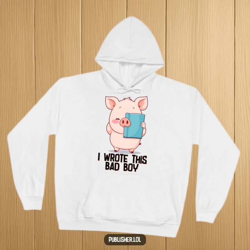 Funny hoodie with a plump, proud pig character holding a newly printed book, ideal for cozy reading.