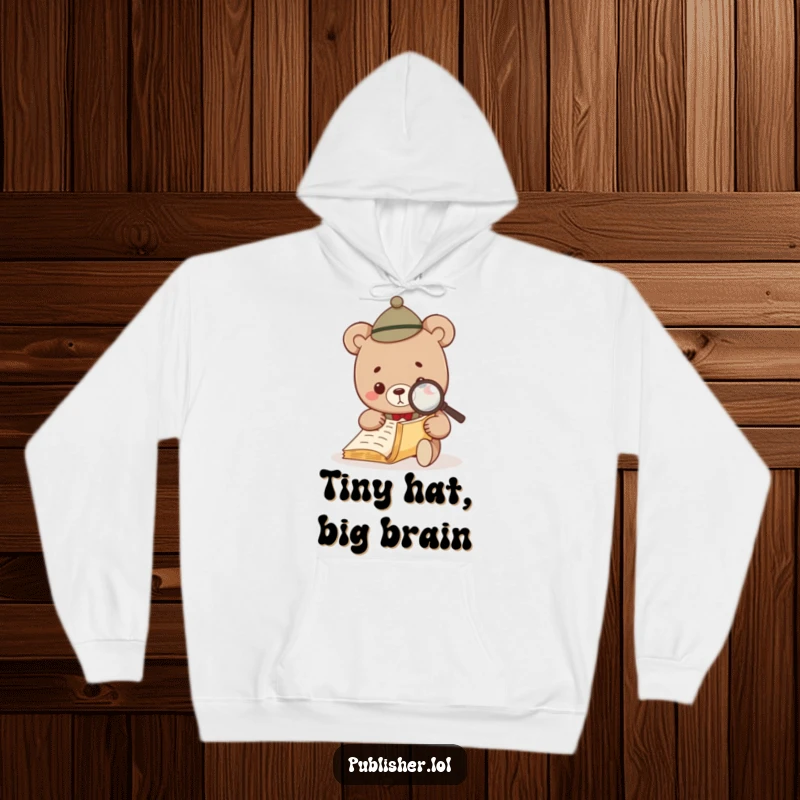 Funny Bear Investigator Hoodie featuring a cute bear in a hat, intently examining a manuscript with a magnifying glass.